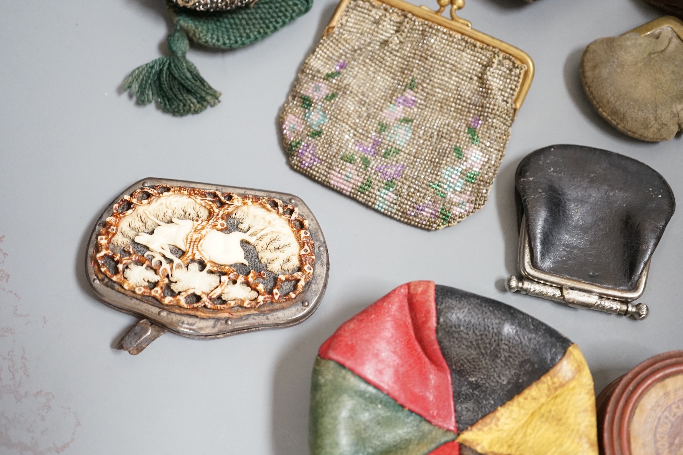 A collection of mostly Grand Tour, wooden souvenir purses and other 19th and 20th century leather and fur purses